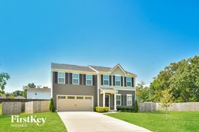 La Vergne house for rent - a house with a garage door and a lawn