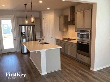 Commerce City house for rent - a kitchen with an island and stainless steel appliances