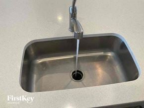 Commerce City house for rent - a stainless steel sink with a faucet