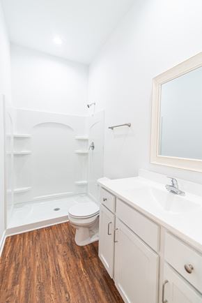 Martinsburg apartment for rent - a bathroom with white cabinets and a toilet and a shower