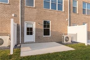 Martinsburg apartment for rent - a patio in front of a brick building with a white door