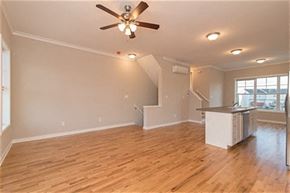 Martinsburg apartment for rent - an empty living room and kitchen with a ceiling fan