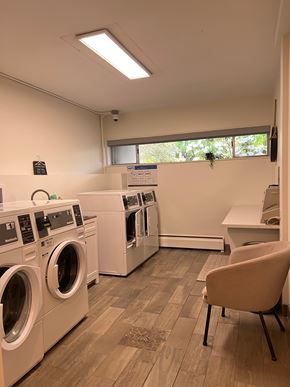 Nanaimo apartment for rent - A laundry room with washing machines and a chair.