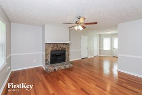 Dallas house for rent - A living room with a fireplace and wood floors.