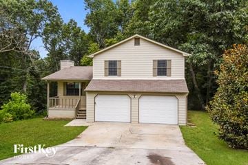 Flowery Branch house for rent - a white house with a white garage with a driveway
