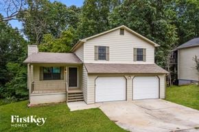 Flowery Branch house for rent - a white house with a garage and a driveway