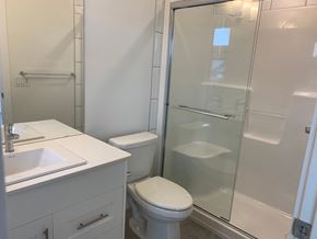 Edmonton apartment for rent - a white bathroom with a shower toilet and sink