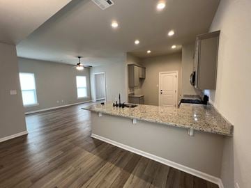 Lafayette house for rent - a kitchen and living room with a granite counter top