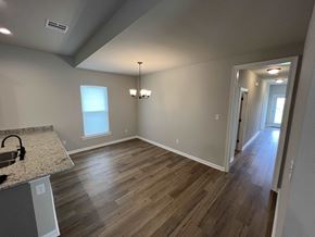 Lafayette house for rent - a dining room and living room with hard wood floors and a window