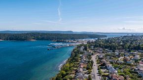 Nanaimo apartment for rent - A coastal town with a body of water and a clear sky.