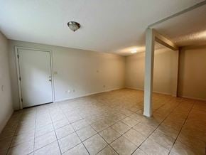 Bay City house for rent - A room with a white door and tiled floor.