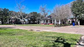 Bay City house for rent - a house on the corner of a street with grass and trees