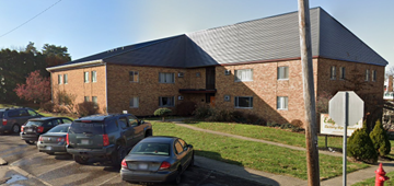 Cambridge apartment for rent - a large brick building with cars parked in front of it