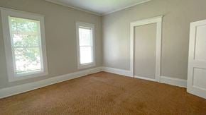 Bay City house for rent - an empty room with two windows and a carpet