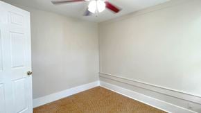 Bay City house for rent - an empty room with white walls and a ceiling fan