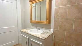 Bay City house for rent - a small bathroom with a sink and a mirror