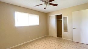 Bay City house for rent - A room with a ceiling fan and a window.