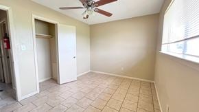 Bay City house for rent - A room with a ceiling fan and tile flooring.