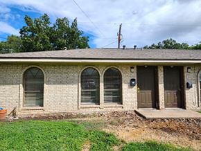 Bay City house for rent - the front of a brick building with a porch and a door
