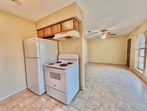 Bay City house for rent - an empty kitchen with a refrigerator and a stove