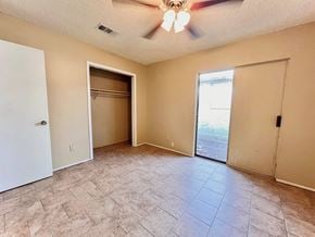 Bay City house for rent - an empty living room with a closet and a ceiling fan