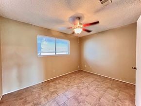 Bay City house for rent - an empty living room with a ceiling fan and a window