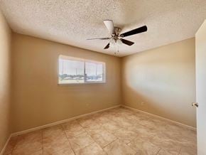 Bay City house for rent - an empty bedroom with a ceiling fan and a window