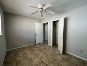 Bay City house for rent - the living room of an empty house with a ceiling fan