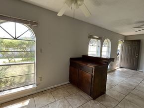 Bay City house for rent - an empty living room with a dresser and a window