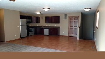 Brandon apartment for rent - A kitchen with a refrigerator, microwave, oven, and cabinets.