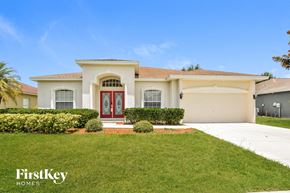 Winter Haven house for rent - A house with a red door and a sign that says "FirstKey Homes".