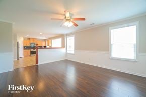 Nashville house for rent - A spacious room with wooden floors and a ceiling fan.