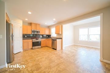 Nashville house for rent - A kitchen with wooden cabinets and a refrigerator.