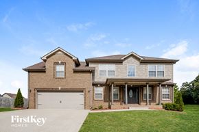 Clarksville house for rent - a large brick house with a white garage door