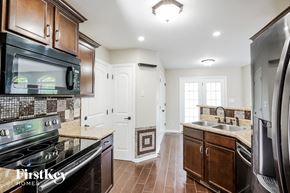 Clarksville house for rent - a kitchen with a stove microwave and a sink