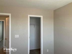 Aurora house for rent - an empty closet in a room with a door to a closet
