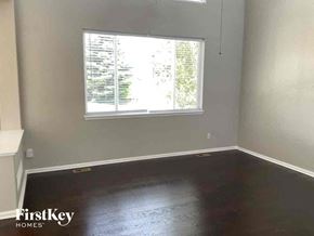 Aurora house for rent - an empty room with wooden floors and a window