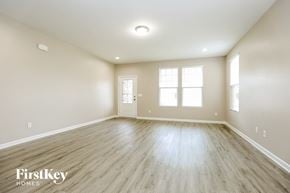 Murfreesboro house for rent - an empty living room with wood floors and white walls