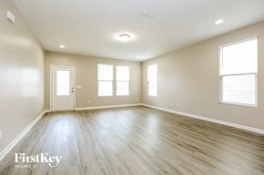 Murfreesboro house for rent - an empty living room with white walls and wood floors