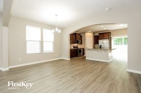 Murfreesboro house for rent - an empty living room and kitchen with wood flooring