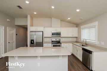 West Melbourne house for rent - a white kitchen with stainless steel appliances and white counter tops