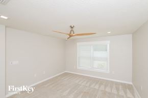 West Melbourne house for rent - a bedroom with a ceiling fan and a window