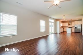 Canal Winchester house for rent - A spacious room with wooden floors and a ceiling fan.
