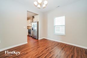 Canal Winchester house for rent - A kitchen area with wooden floors and a refrigerator.