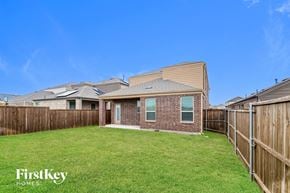 Mckinney house for rent - A house with a fence and a grassy yard.