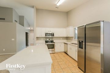 Glendale house for rent - a large kitchen with stainless steel appliances and white cabinets
