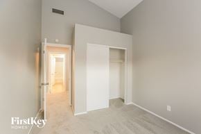 Glendale house for rent - a bedroom with a closet and a hallway with an open door