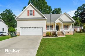 Concord house for rent - a white house with a driveway and a white garage door