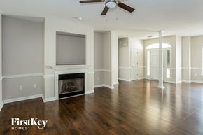 Concord house for rent - an empty living room with a fireplace and a tv
