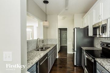 Concord house for rent - a kitchen with stainless steel appliances and granite counter tops